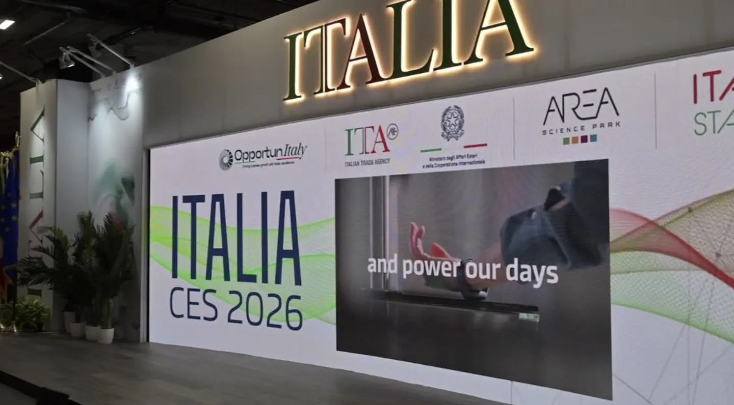 The stand from the aisle, an Italia sign above the entrance and two screens running the show graphics.
