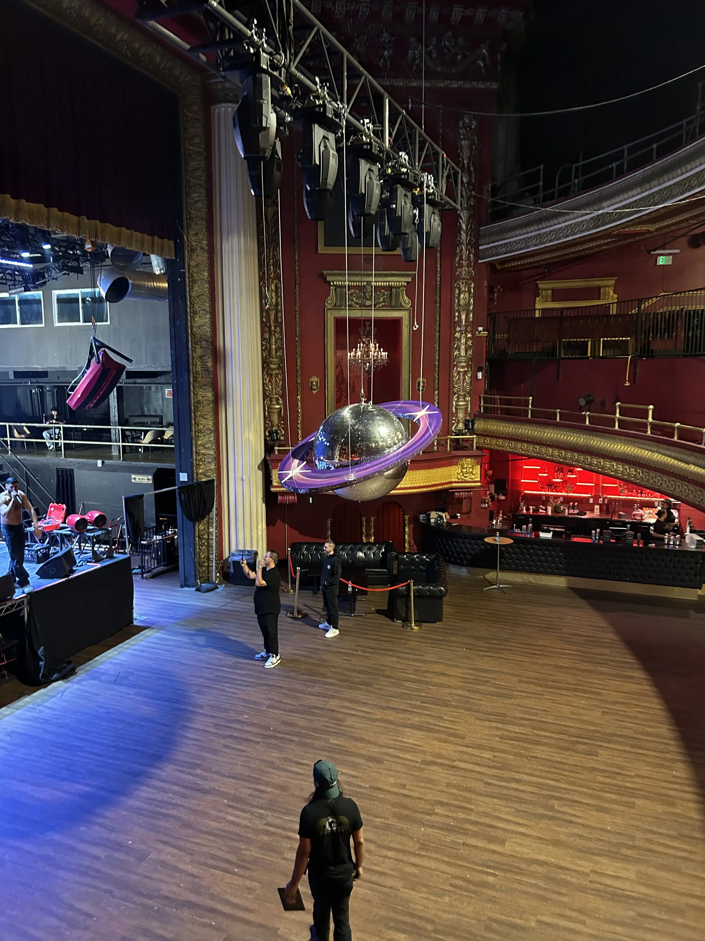 The empty dance floor and the balcony seats above it, with the ring rig hung over the middle of the room.